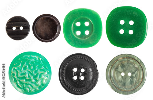 Isolated photo of various vintage green, khaki and black colored plastic decorative cloth buttons or rivets on white background.