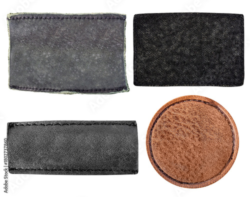 Isolated photo of worn black and brown suede and leather patches with border stitching on white background.