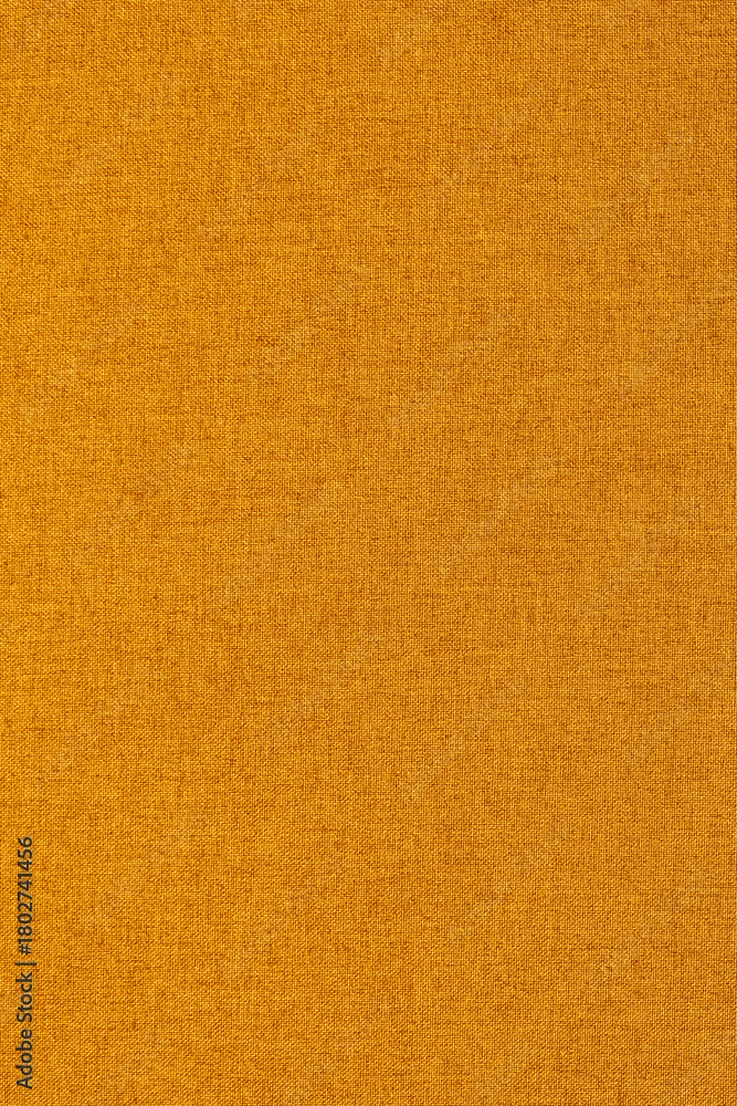 Fototapeta premium Close-up of a orange softshell waterproof outdoor hiking jacket background backdrop.