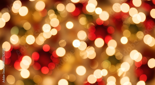 Blurry Christmas lights with red and gold decorations in the background  