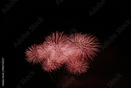 happy friends celebrate life together as they ignite dazzling fireworks in night sky