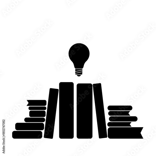 Silhouette of lightbulb over books symbolizing knowledge and learning, education and inspiration