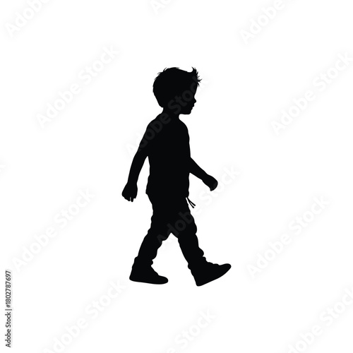 A silhouette of a young boy walking to the right side of the frame against a white background view side