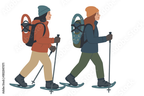 Two women trek in winter, walking with snowshoes mounted on their backpacks
