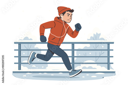 A determined young male athlete jogs across a footbridge, listening to music in the winter