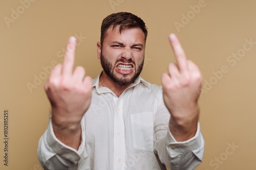 Картината върху платно portrait of young man shows anger and defiance by raising both middle fingers on