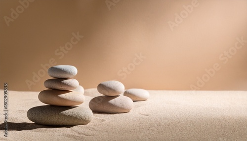 Canvas Print zen inspired composition of smooth river stones arranged vertically on sand back
