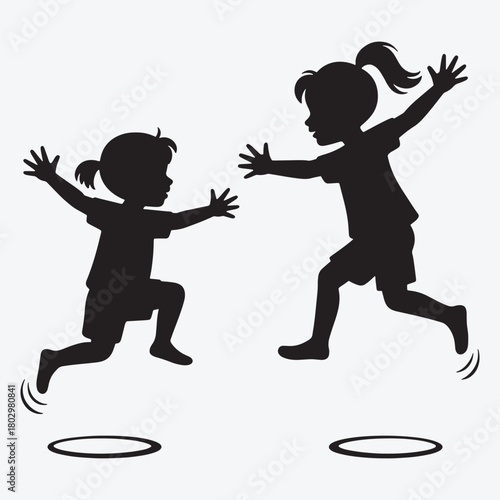 Two black silhouette children jumping with arms outstretched towards each other over hoops kids playing