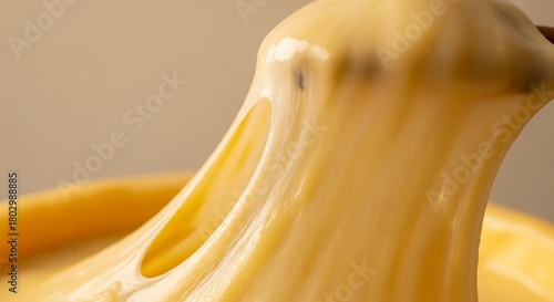 Close minimalist view of cheese stretching with smooth warm creamy texture