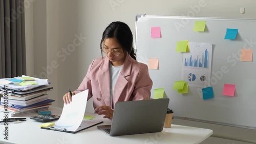 Businesswoman, office worker stressed out from laptop use, overwork, and accounting document errors. Office syndrome concept.