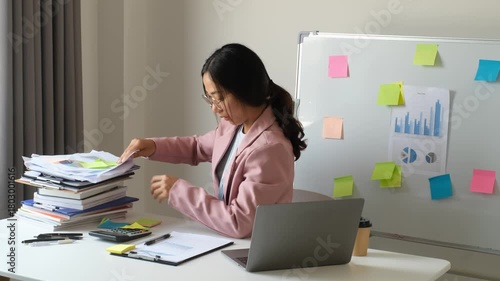 Businesswoman, office worker stressed out from laptop use, overwork, and accounting document errors. Office syndrome concept.