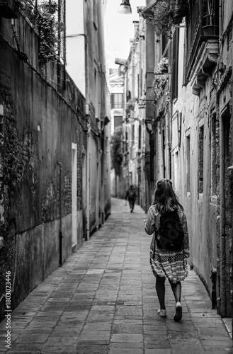 Calle angosta en Venecia (mujer de espaldas caminando)
