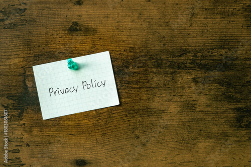 There is a piece of paper with the word Privacy Policy. It is as an eye-catching image.
