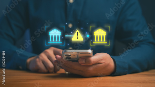 Quadro su tela Person using a smartphone with digital bank icons and a warning symbol, illustrating online banking risks, payment transfer issues, security alerts, scammer, and financial transaction protection