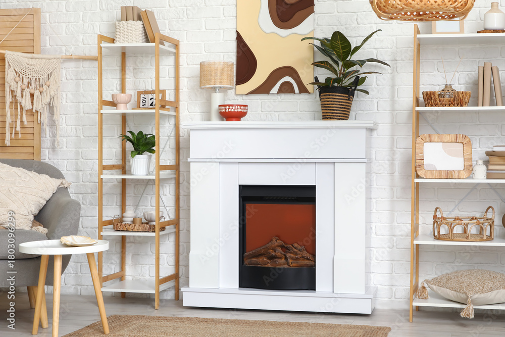 Naklejka premium Interior of modern living room with fireplace, shelving units and armchair