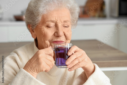 Senior woman drinking butte...