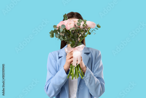Young woman with bouquet of...
