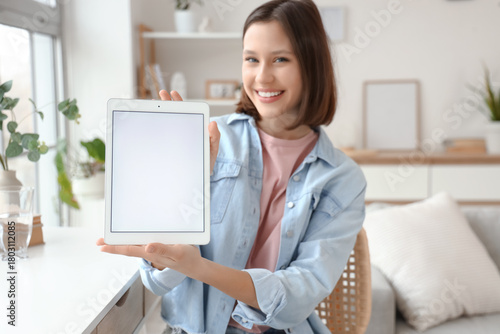 Smiling young woman holding...