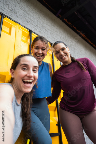 Three latin hispanic women smiling, feeling joyful and fit after exercising. Enjoying friendship and a healthy lifestyle