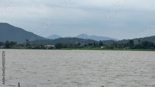 a view of river with mountains in the background