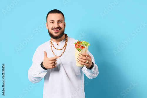 Young Muslim man pointing a...