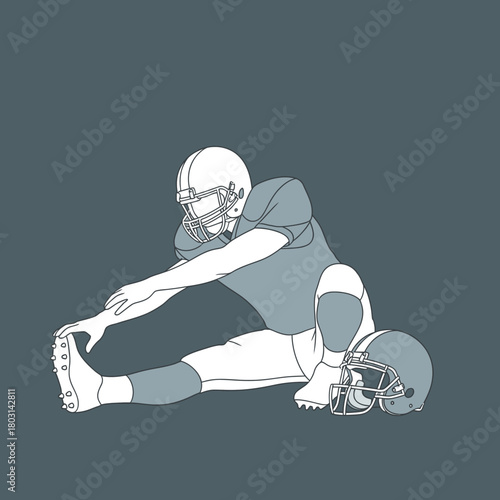Football player stretching his leg while sitting on the ground, preparing for a game.