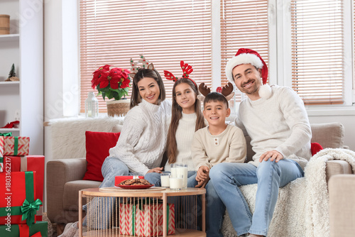 Happy family on sofa celebr...