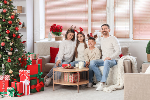 Happy family on sofa celebr...