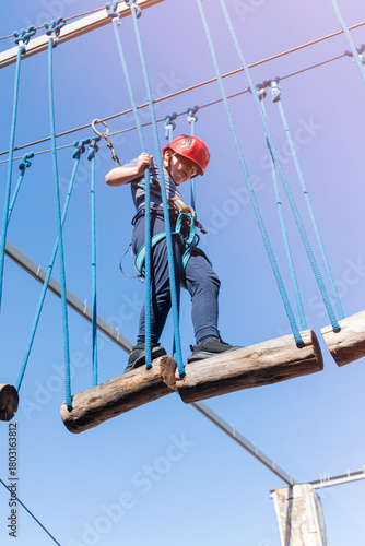 Wallpaper Mural Child boy in Protective Gear Navigating a High Ropes Course in adventure park  Torontodigital.ca