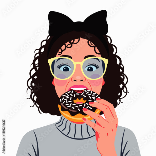 A woman with curly hair and glasses, wearing a bow, enjoys a chocolate donut with sprinkles, expressing delight in the sweet treat.