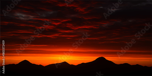 Sunset over mountain landscape with colorful sky and clouds