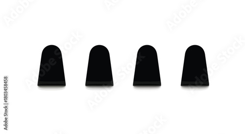 Four black thimbles lined up for sewing use