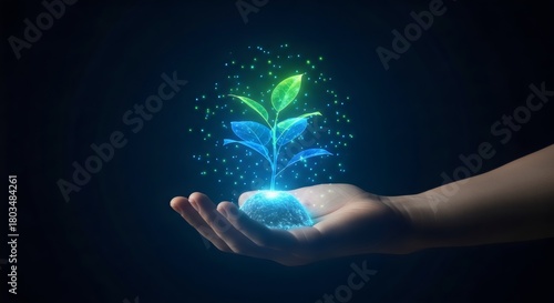 Concept of green technology and environmental conservation, with a glowing plant hologram growing from a hand, symbolizing a sustainable future and innovation