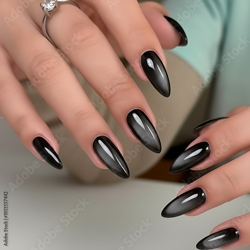 Glamorous black cat eye stiletto nails for a chic modern woman with soft neutral