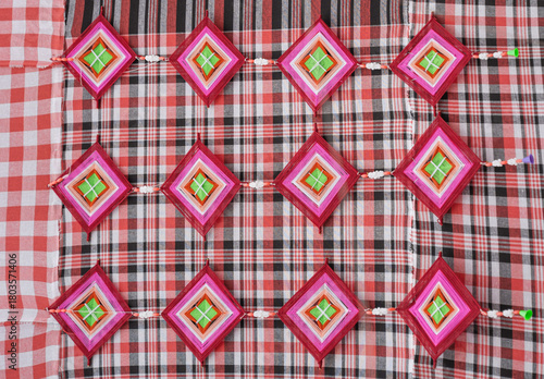 Weaving silk into a spider web pattern on a plaid cotton fabric
