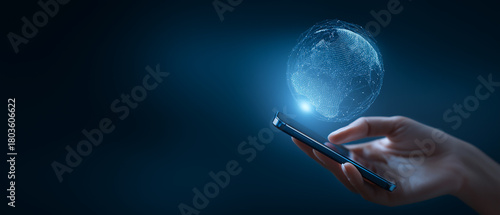 Hand holding smartphone displaying holographic digital globe with glowing network connections