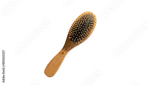 Oval wood hairbrush shows bristles. Isolated against black