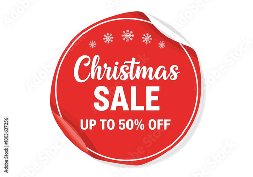 A red Christmas sale sticker with white text and snowflake accents, curled edge.