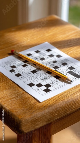Solving a challenging crossword puzzle on a wooden table
