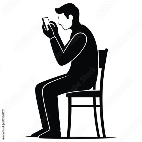 Man sitting on chair looking at smartphone screen with focused expression