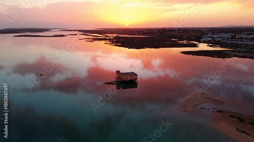 Aerial shot above the life boat station in Fuseta ans Ria Formosa natural park in Algarve region at sunset with beautiful colors, Portugal