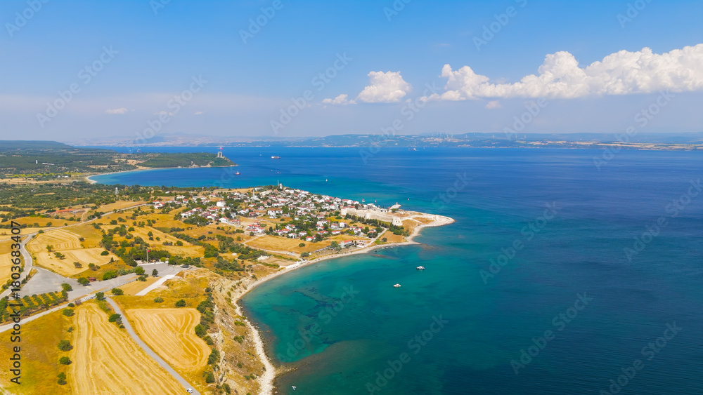 Obraz premium Seddulbahir, Eceabat, Turkey. Historic Mehmetcik Feneri lighthouse standing at entrance to Dardanelles Strait with panoramic view of Aegean Sea coastline. Aerial drone view.. Aerial View