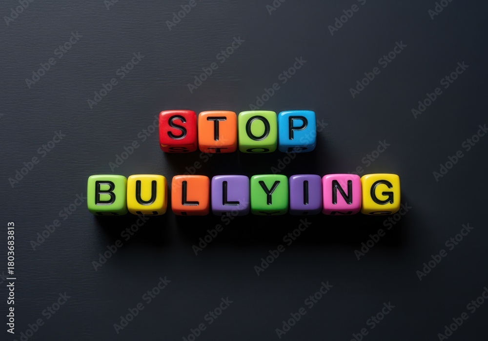 Obraz premium Colorful plastic blocks spelling stop bullying on a dark smooth background creating a bold simple scene that highlights a clear message about awareness support and safety