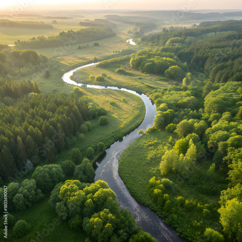 Aerial View of Winding River Flowing Through Lush Green Landscape.