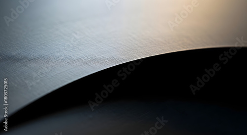Closeup of a sharp metal blade with a serrated edge, showing the texture and detail of the steel under dramatic lighting conditions