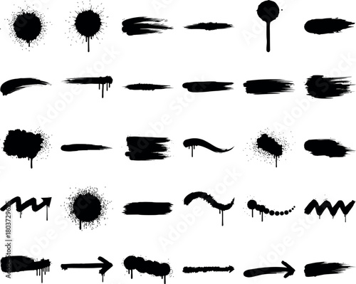 Collection of black spray paint splatters and brush strokes on white background