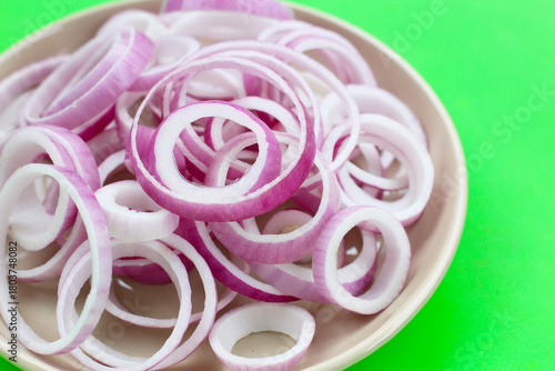 Sliced red onion rings in white plate