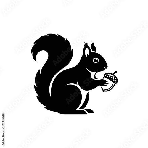 Black Silhouette of a Squirrel Holding an Acorn.
