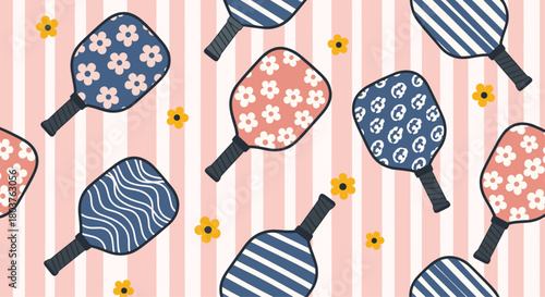 A playful seamless pattern featuring various pickleball paddles with diverse prints and scattered yellow flowers on a pink and white striped background.
