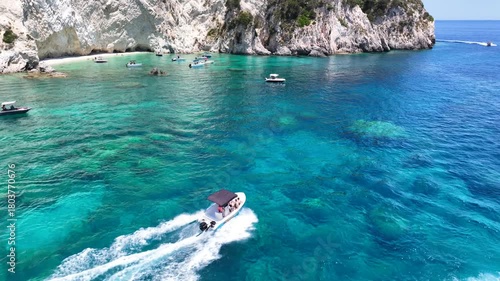 Aerial drone cinematic video of paradise bay with scenic white cliffs covered with limestone and sea caves creating a blue lagoon in tropical exotic destination island